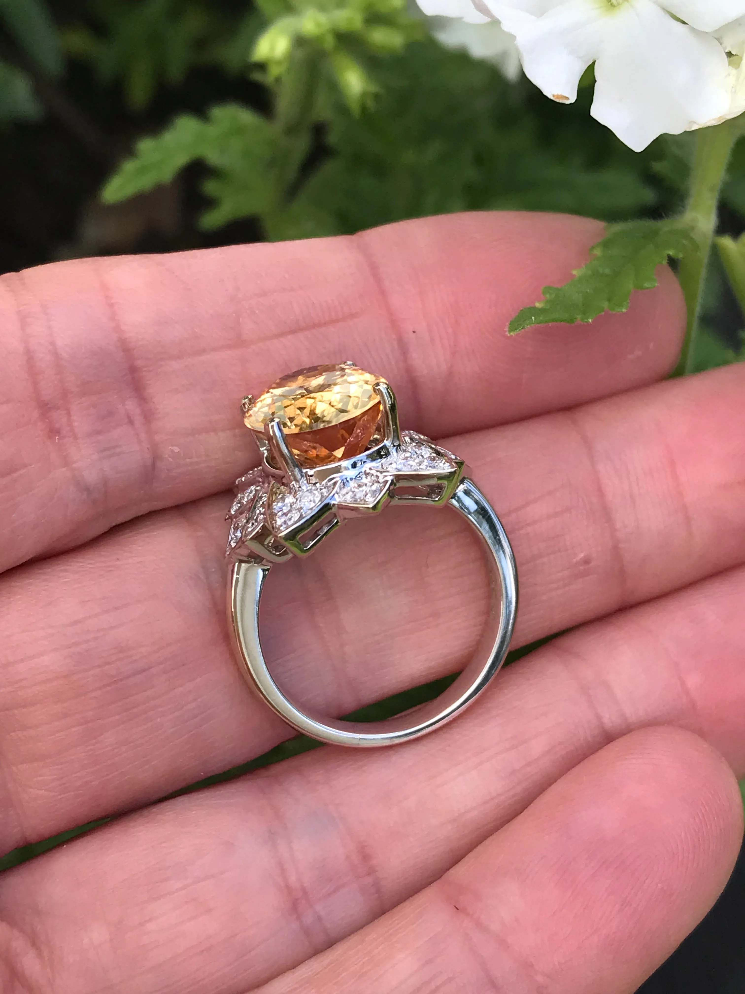 White gold imperial topaz ring set with a floral diamond surround