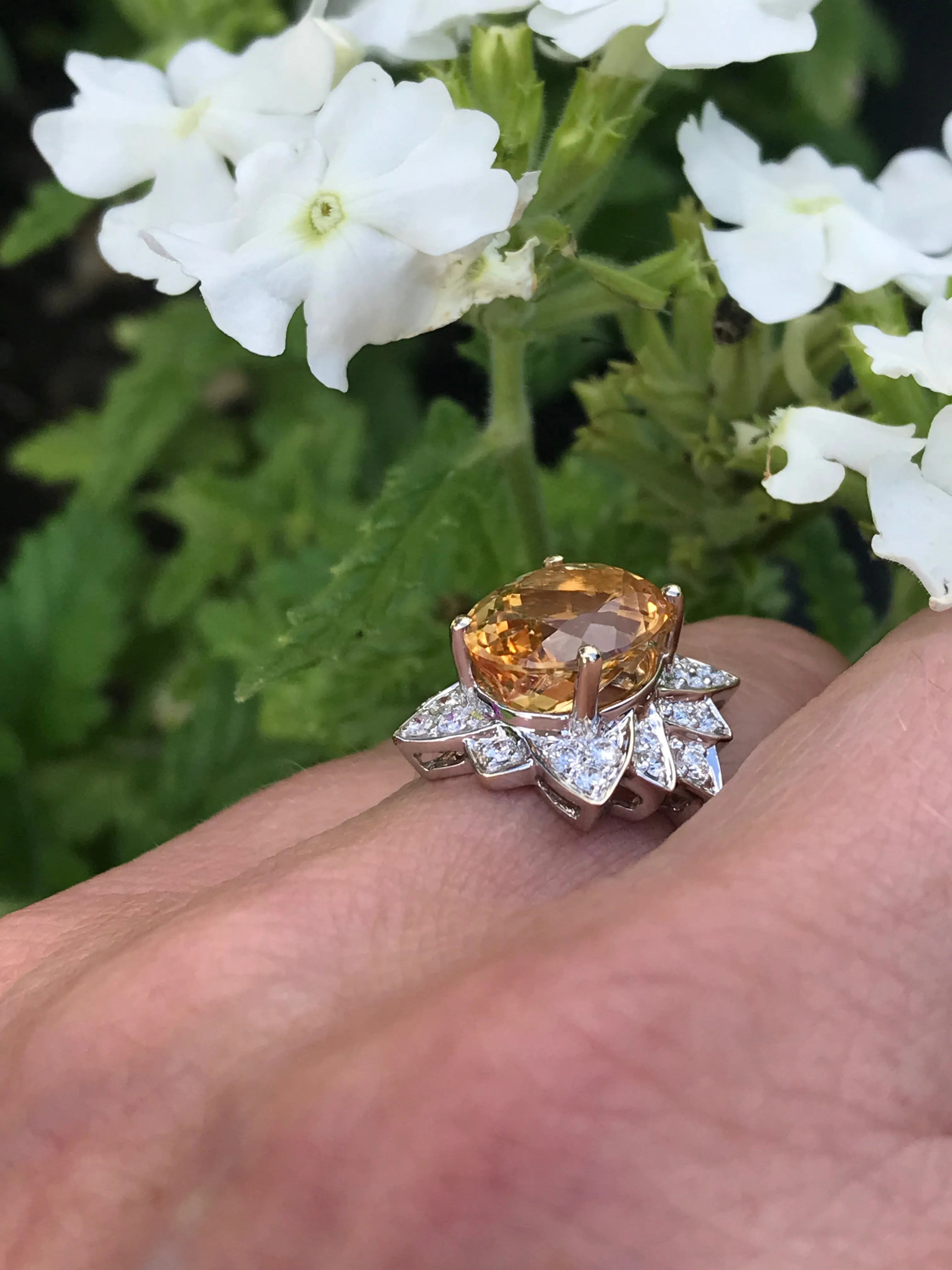 White gold imperial topaz ring set with a floral diamond surround