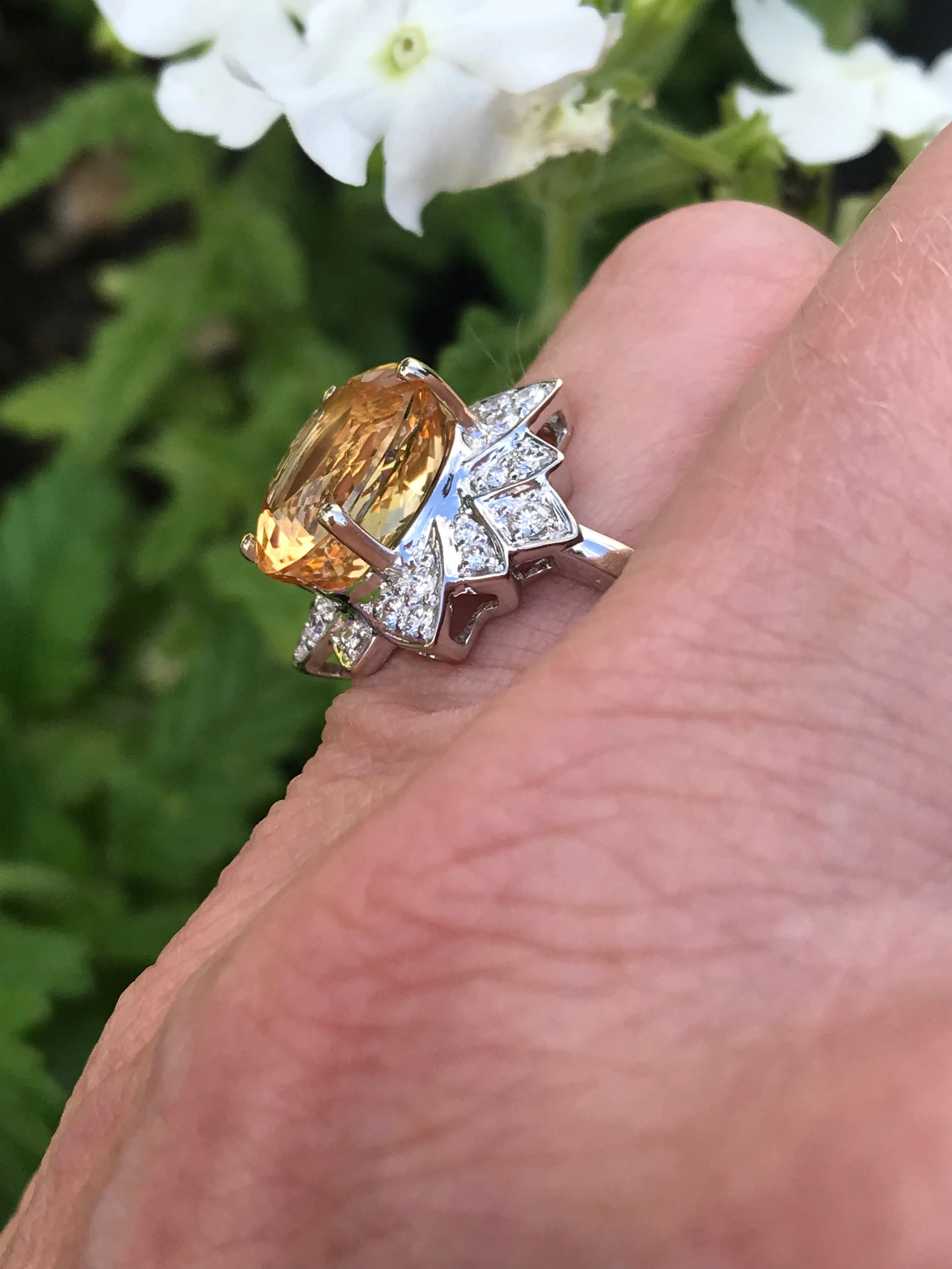 White gold imperial topaz ring set with a floral diamond surround