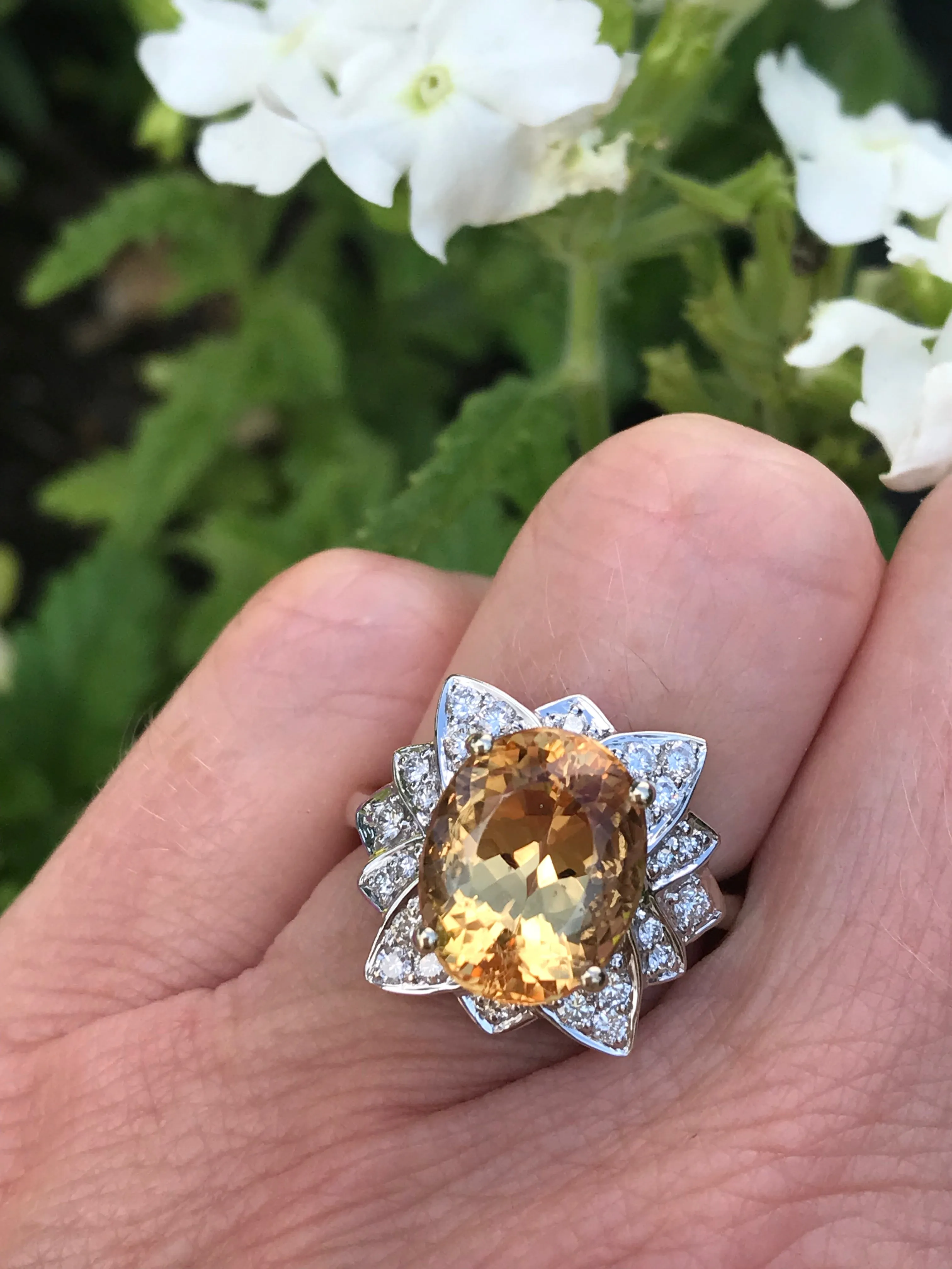 White gold imperial topaz ring set with a floral diamond surround